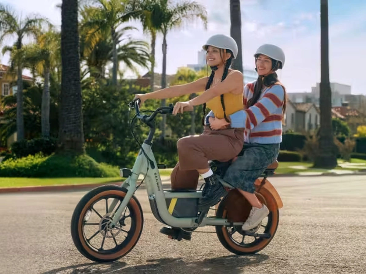 Woman riding a Segway MUXI e-bike with a child passenger