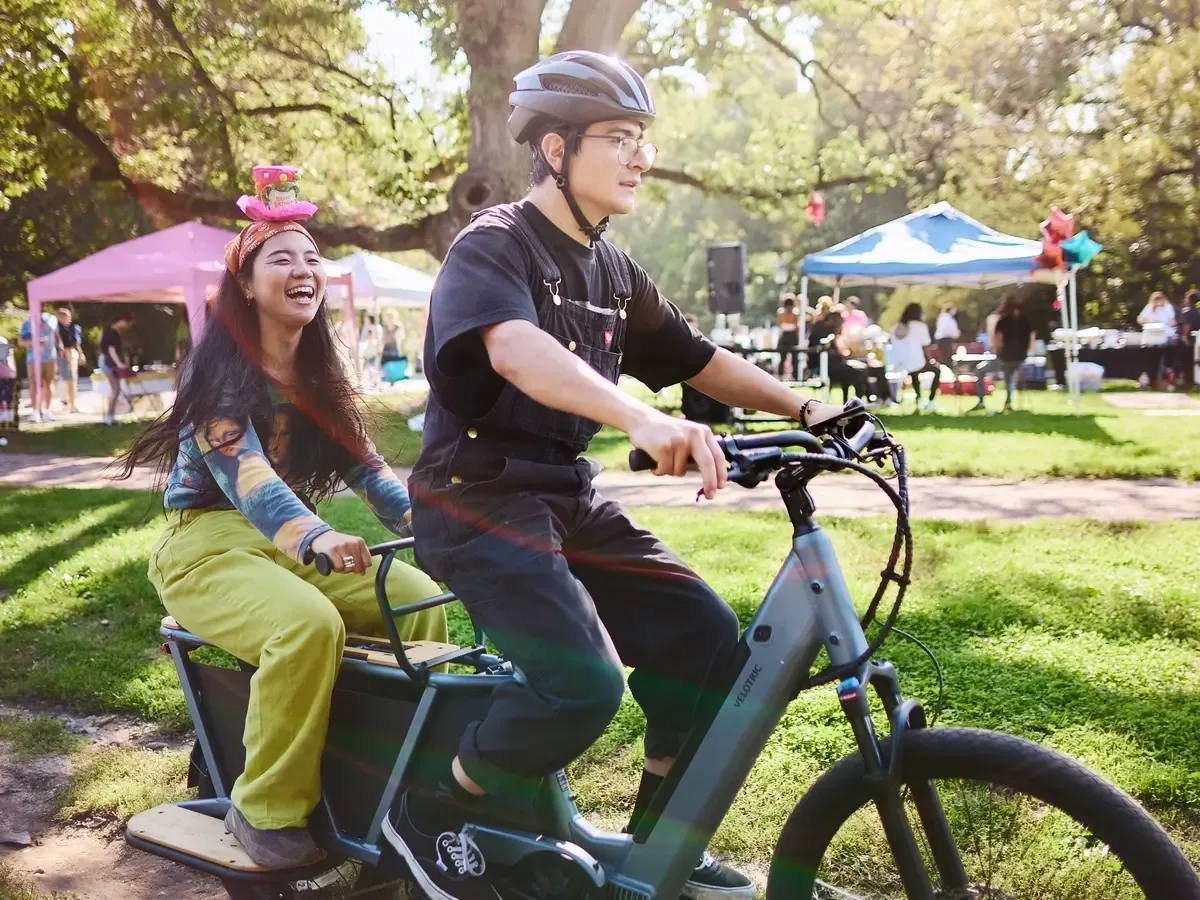Two riders exploring outdoors on a cargo e-bike